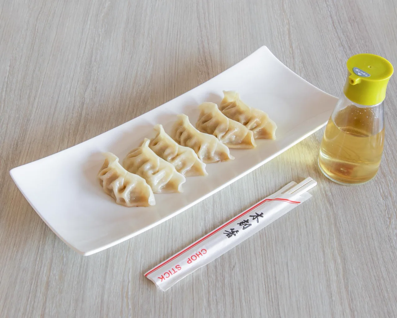 Handmade chicken dumplings on a long white plate